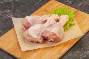 Raw chicken drumsticks for cooking photo