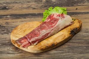 Raw beef bacon over wooden board photo