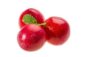 Bright ripe plum with mint photo