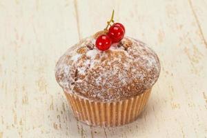 Sweet tasty muffin with red currants photo