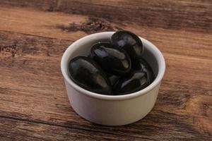 Pickled black olives in the bowl photo