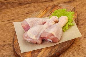 Raw chicken drumsticks for cooking photo