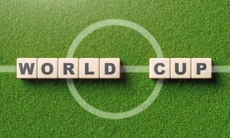 World cup word alphabet on wooden block cube in soccer field with center line. Sport and tournament concept. 3D illustration rendering photo