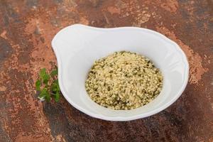 Peeled hemp seeds in the bowl photo