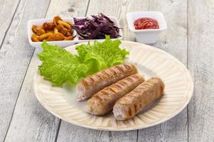 Grilled sausages served mushrooms and cabbage photo