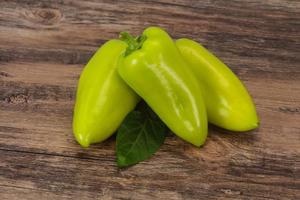 Green bell pepper over wooden background photo