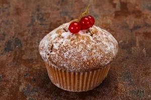 Sweet tasty muffin with red currants photo