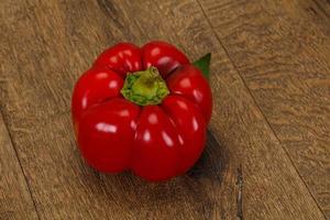 Ripe Red bell pepper over wooden photo