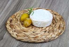 Brie cheese with yellow plums photo