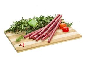 Salami with rosemary, basil and tomato photo