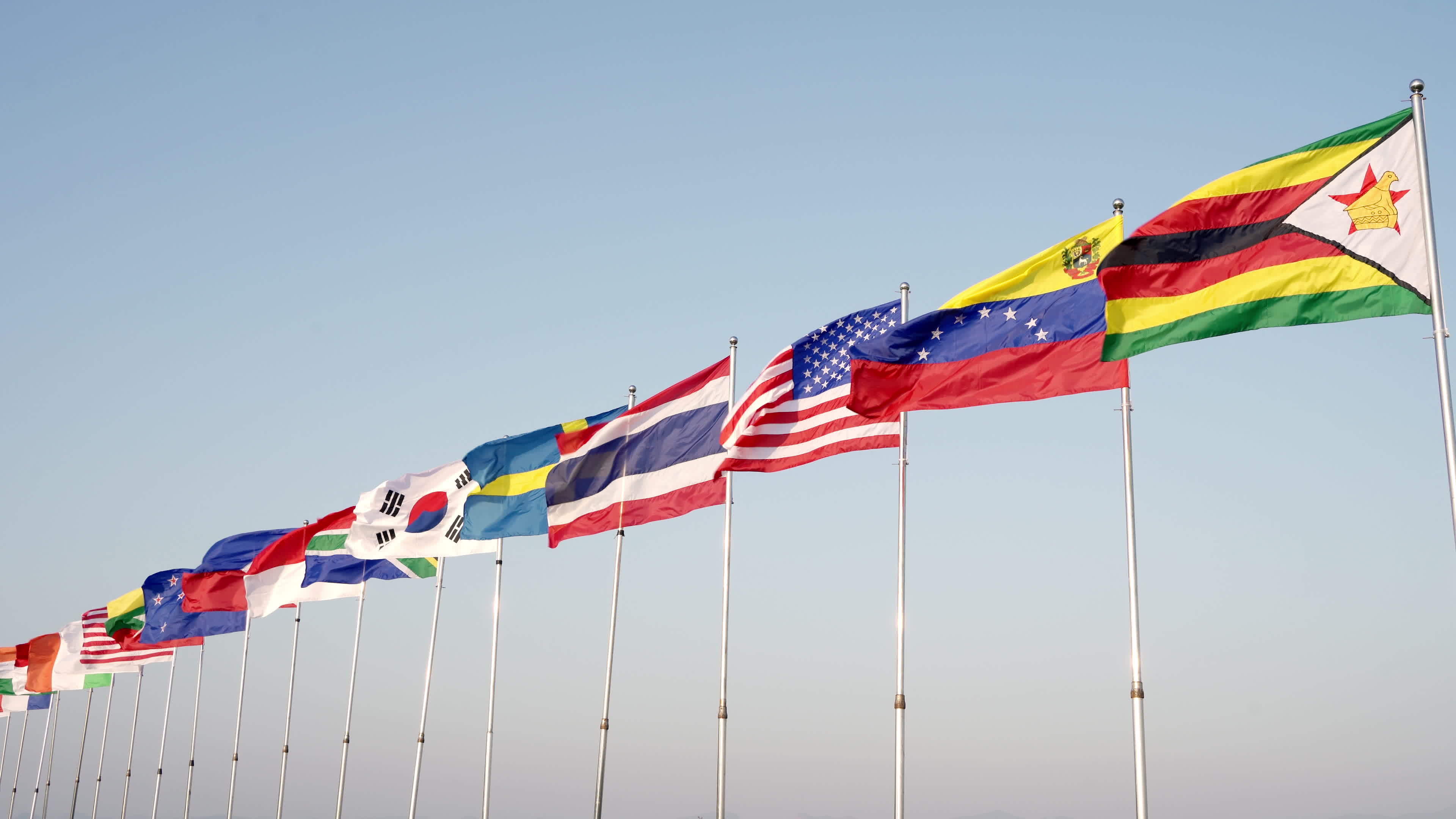 Many international flags wave outdoors for sporting events, the symbol