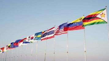 Many international flags wave outdoors for sporting events, the symbol represents harmony video