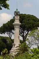 small lighthouse between the trees in Rome, Italy photo