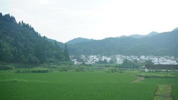 The beautiful Chinese countryside village view with  the old traditional buildings surrounded by the natural environment photo