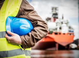 Shipbuilding engineer with safety helmet in shipyard photo
