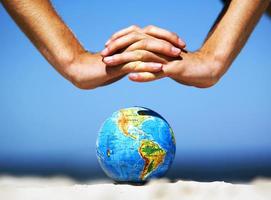 Earth globe with hands over it. Conceptual image photo