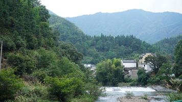 The beautiful Chinese countryside village view with  the old traditional buildings surrounded by the natural environment photo