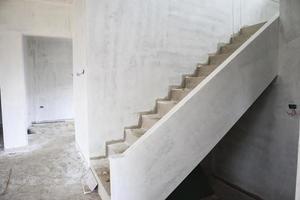 New house construction with concrete staircase at building site photo