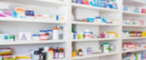 Pharmacy drugstore blur abstract backbround with medicine and healthcare product on shelves photo