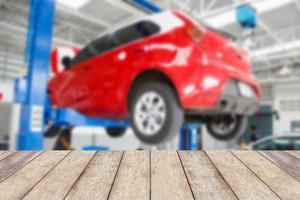 Wood table top with blur car service centre background photo