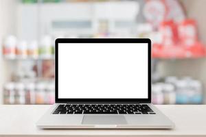 pharmacy store counter table top with blank screen laptop computer photo