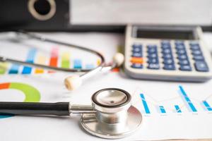 Stethoscope on spreadsheet paper, Finance, Account, Statistics, Investment, Analytic research data economy spreadsheet and Business company concept. photo
