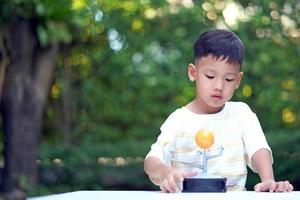 Asian boy Living Solar System Toys, Home Learning Equipment, during new normal change after coronavirus or post covid-19 outbreak pandemic situation photo