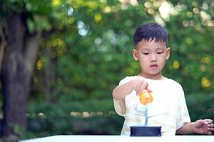 Asian boy Living Solar System Toys, Home Learning Equipment, during new normal change after coronavirus or post covid-19 outbreak pandemic situation photo