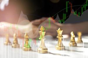 Close-up of a game of chessboard with chess pieces. Chessboard Concept vs. Business Management on Risk, Graphic Charts Showing Financial Flows and Business Performance. Risk management. photo