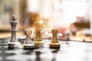 Close-up of a game of chessboard with chess pieces. Chessboard Concept vs. Business Management on Risk, Graphic Charts Showing Financial Flows and Business Performance. Risk management. photo