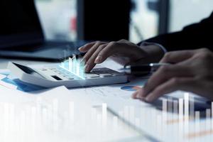 A business man examines data on financial documents, company financial reports, graphics showing financial and numerical growth data. The concept of financial management to grow and be profitable. photo