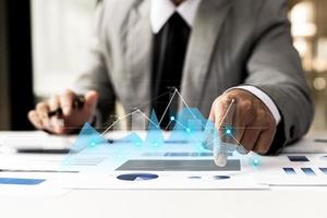 A businesswoman examines data on financial documents, company financial reports, graphics showing financial and numerical growth data. The concept of financial management to grow and be profitable. photo