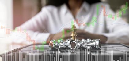 Close-up of a game of chessboard with chess pieces. Chessboard Concept vs. Business Management on Risk, Graphic Charts Showing Financial Flows and Business Performance. Risk management. photo