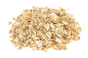 Heap of dry rolled oats isolated on white background photo