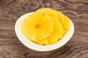 Marinated pineapple rings in the bowl photo