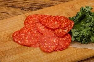 Italian spycy pepperoni sausage slices photo