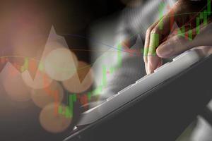 Businesswoman presses a calculator to check data on documents, company financial reports, graphics showing financial and numerical growth data. Financial management to grow and be a profitable concept photo