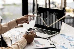 A business man examines data on financial documents, company financial reports, graphics showing financial and numerical growth data. The concept of financial management to grow and be profitable.
