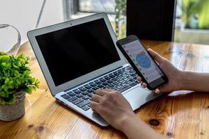 Person holding a smartphone at the screen showing an email application, using a smartphone to send and receive electronic mail. Concept of using smartphones and sending and receiving emails online. photo