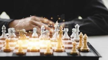 Close-up of a game of chessboard with chess pieces. Chessboard Concept vs. Business Management on Risk, Graphic Charts Showing Financial Flows and Business Performance. Risk management. photo