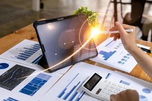 A business man examines data on financial documents, company financial reports, graphics showing financial and numerical growth data. The concept of financial management to grow and be profitable. photo