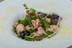 Rucola with squid salad photo