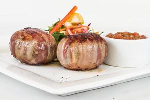 Grilled steak wrapped in bacon, with grilled vegetables, mashed potatoes photo