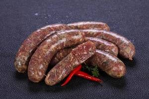 Raw lamb sausages photo