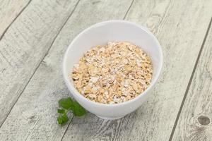 Raw oats in the bowl photo