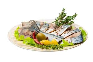 Mackerel fish, sliced on a plate with lettuce photo