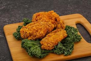 Hot fried crispy chicken wings photo