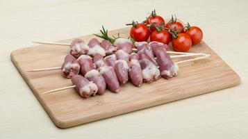 Raw chicken hearts for barbecue photo