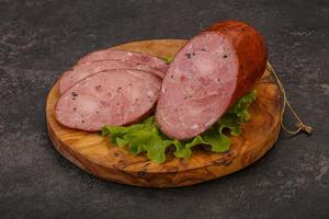 Smoked ham sausage with spices photo