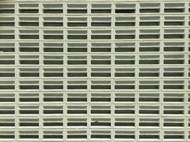 Front view of a series of light green concrete ventilation blocks photo